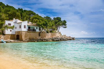 Transparent waters and sandy shore in Cala Gat beach in Mallorca