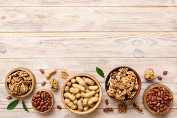 Walnut kernel halves, in a wooden bowl. Close-up, from above on colored background. Healthy eating Walnut concept. Super foods with copy space