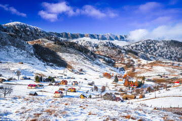 Carpathian Mountains, Romania. Charming winter snowy landscape with rural Rucar-Bran touristic...