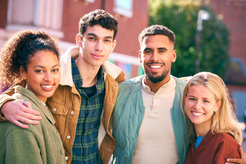 Portrait Of Multi Cultural Group Of 20 Year Old Friends Hanging Out Together In Urban Setting