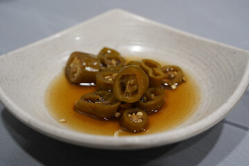 A traditional Korean side dish made by pickling green peppers in salt water, soaking them in soy sauce and fermenting them.
