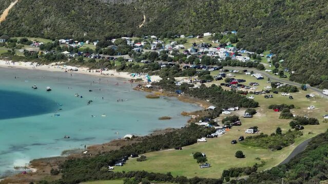 Aerial: Camp ground and holiday makers at the lake. Kai Iwi Lakes. Dargaville, Northland, New Zealand