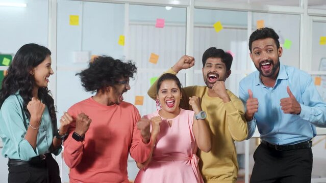 Group of team members or corporate employees shouting celebration the success at office - concept of business deal, achievement and motivation