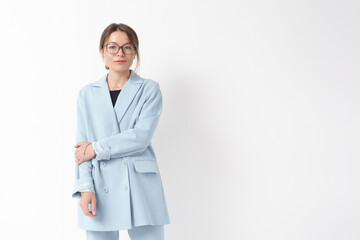 Elegantly dressed businesswoman in a pastel blue blazer and eyeglasses, presenting a smart and...