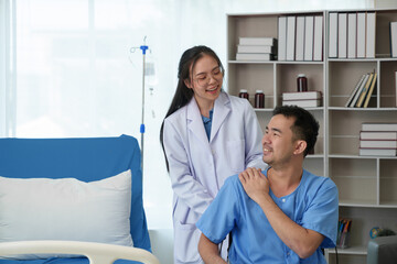 A caring female doctor provides medical care to an Asian male patient in a wheelchair in the hospital. Emphasizing the importance of health care from experts and care, treatment, and medical services