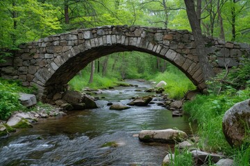 Fototapeta na wymiar Old stone bridge arching over a gentle stream