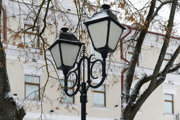   Vitebsk, Belarus, January 5, 2024. Vintage lanterns among the trees against the background of the...