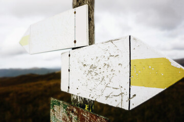 Hiking trail arrow. Mountain cloudy weather landscape. Empty copy space blank guide arrow. Walking...