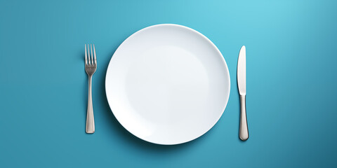 empty white plate with cutlery.  isolation on a blue background - obrazy, fototapety, plakaty