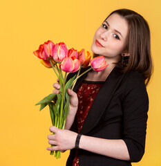 Young cute teen brunette girl with tulips