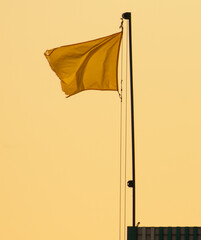 Yellow flag against a blue sky