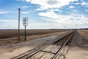 Train tracks passing by old cotton plantation on clear day - 707096048