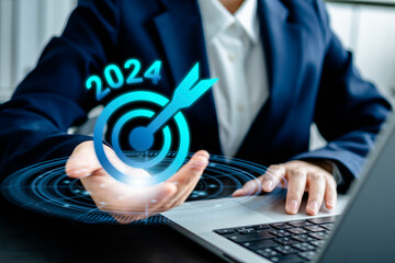 Businesswomen holding dartboard icon virtual, business plan road to goals 2024. target planning...