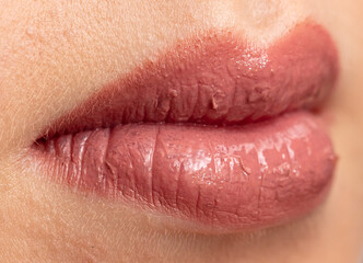 Close-up of a girl's lips in lipstick. Macro