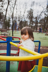 Fototapeta na wymiar A very cute young girl is having fun in the playground.