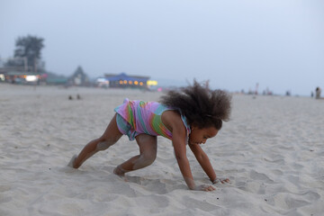 Fototapeta premium Charming African American girl is doing sports on summer day at beach. Outdoor activities. 