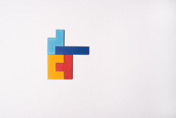 Colorful puzzle on white background. Multi-colored heart as a symbol of World Autism Awareness Day. Flat lay, copy space