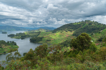 Idyllische Seenlandschaft mit Inseln, Wolken, Bergen und viel Grün in Ostafrika