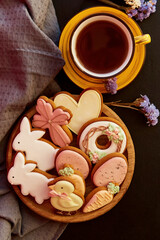 Aesthetics festive Easter cookies, cups of tea close up. Holiday food, tea time