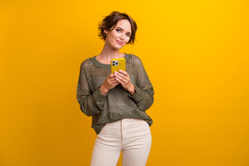Photo of lovely cute girl wear trendy outfit hold modern device apple iphone isolated on yellow...