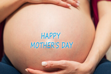 Essence of motherly love with a Happy Mothers Day message lovingly placed on an expectant mothers belly.