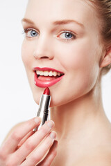 Portrait, application and model in studio with red lipstick, beauty cosmetics and mock up by white background. Woman, foundation and aesthetic for glow face with color product and soft lips results