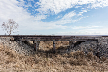 Railroad crossing with old wooden overpass in deep rural Mississippi - 707115484