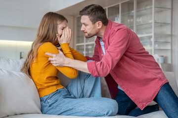 Man tyrant husband beating crying wife during scandal misunderstanding at home. Stressed mad abuser...