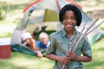Fotobehang Wood, summer camp or portrait of African kid in nature playing, adventure or holiday vacation in park. Relax, collect or happy child with smile or sticks in woods, garden or forest for fun camping © Beak/peopleimages.com