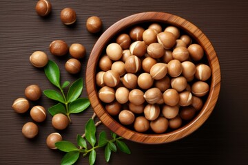 Tasty Macadamia nuts on brown table, flat lay