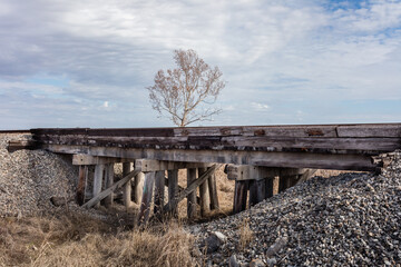 Wooden bridge train crossing over dry riverbed - 707124679