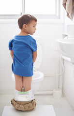 Boy kid, potty training and bathroom with thinking, diaper and pants on floor for learning,...