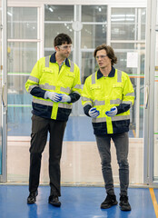 Technician engineers check and repair automatic robotic machines at the industrial factory, Workers work with focused repairing in the industry.