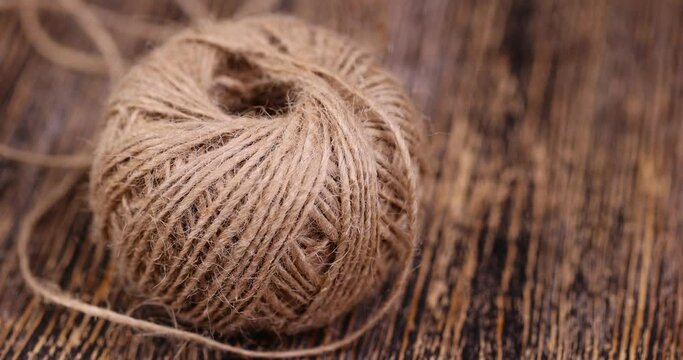 rough linen rope close-up, rough rope on a wooden table