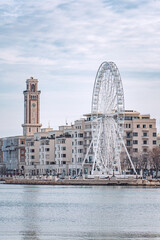 Fototapeta na wymiar Bari, Puglia, Italy - December 30 2023: Panorama of Bari, Puglia or Apulia, southern Italy with Mediterranean Sea, street lamps, ferris wheel and fascist architecture on the seafront promenade