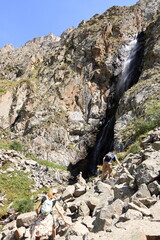 August 19 2023 - Ala Archa national park, Kyrgyzstan, Central Asia: people enjoy a waterfall in the...