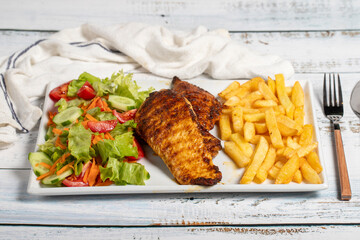Grilled chicken. Grilled chicken breast with salad and fries on a white background