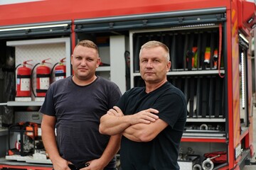A skilled and dedicated professional firefighting team proudly poses in front of their state of the...