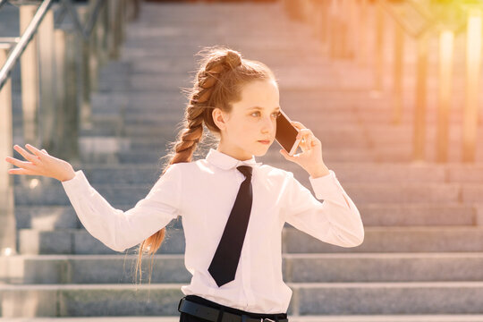 Little school girl having phone talk with friend. modern life communication. Living in digital age.