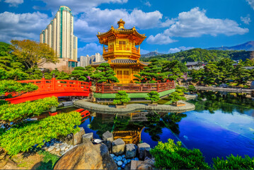 Serene Asian Garden Oasis with Golden Pavilion and Red Bridge Amidst Urban High-rises
