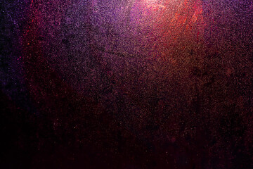 Black dark red blue pink orange golden shiny glitter abstract background with space. Twinkling glow...
