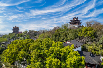 Fototapeta na wymiar Traditional Pagodas on Lush Hilltop under Dynamic Sky, East Asian Historical Site, China