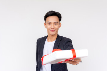 A handsome asian man with boyish looks handing over a nice gift to someone. Isolated on a white...