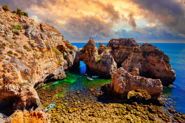 Majestic Cliffs and Natural Archway Overlooking Azure Ocean, Tranquil Cove with Boats, Algarve Coast