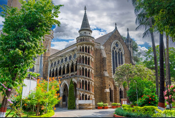 Fototapeta premium Gothic Revival Church, nestled in a Tropical Garden of a Warm Climate Area