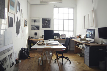 A creative workspace with minimalistic art on the walls.