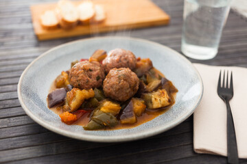 Cooked meatballs with stewed eggplant with haze in bowl