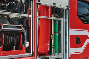 Close-up of essential firefighting equipment on a modern firetruck, showcasing tools and gear ready...