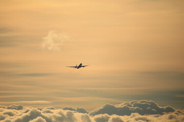 taking off airplane in front of iridescent clouds