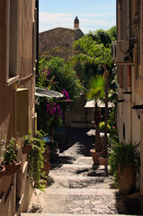 Scenic landscape view of narrow street with staircase between vintage houses in Taormina. Sicily. View of typical street in Taormina. Travel and tourism concept